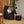 Charger l&#39;image dans la galerie, Bean Bag Cadet et Pouf repose-pieds de couleur onyx noir. Femme assisse buvant un café sur le Bean Bag Cadet Arico. 
