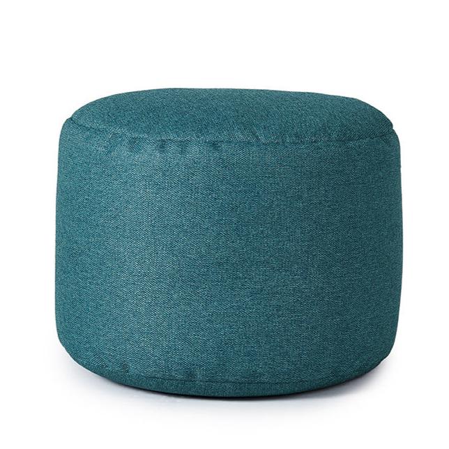 Pouf repose-pieds de couleur sarcelle sur fond blanc.