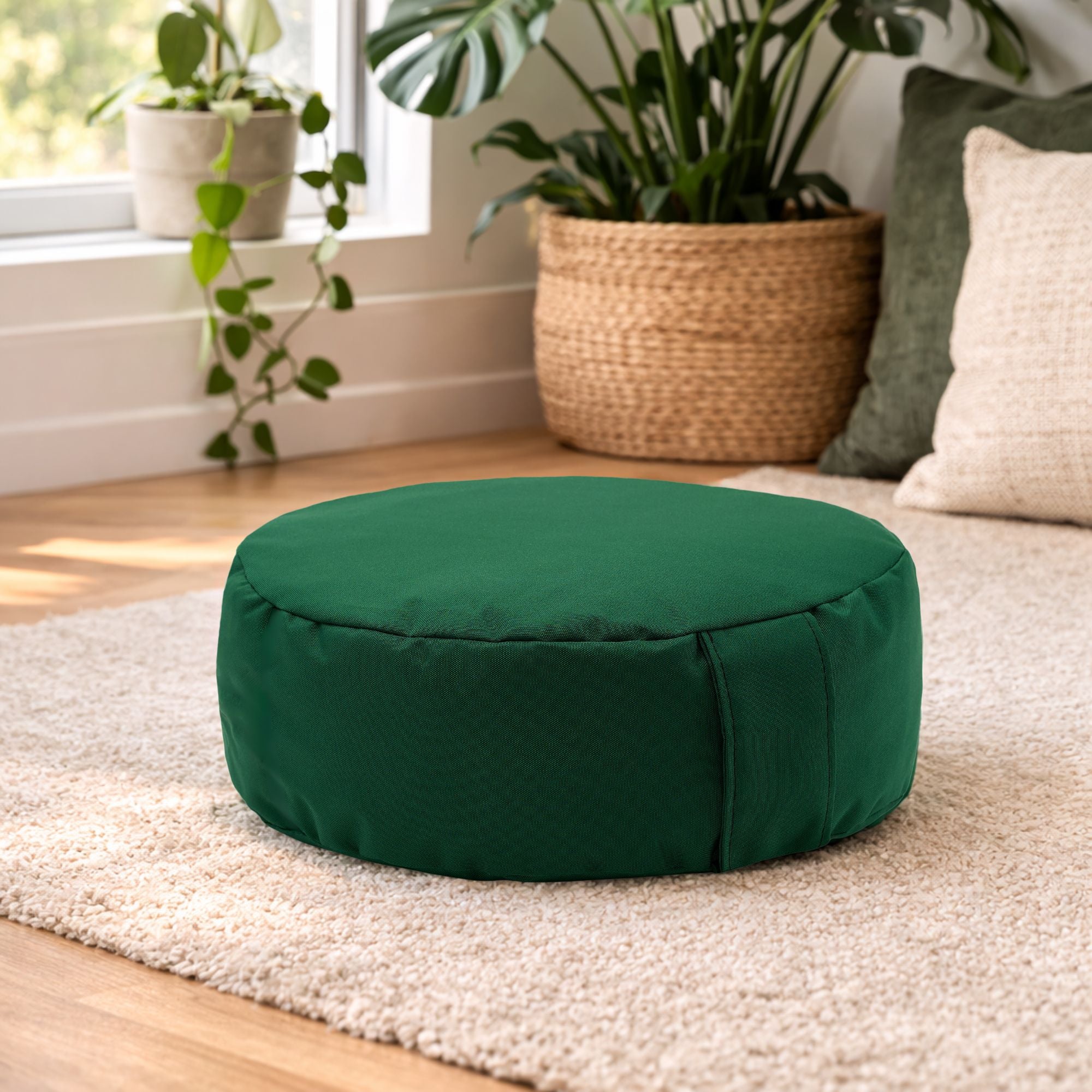 Green ARICO floor cushion used for sitting close to the floor in a bright living room. Ideal for meditation, relaxation, or creating comfortable seating around a coffee table. Made in Canada product.