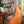 Load image into Gallery viewer, Bean bag ARICO format Cadet de couleur clémentine avec homme travaillant sur son ordinateur. 
