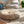 Load image into Gallery viewer, Coussin de sol Arico de couleur sahara dans un décor maison avec jouets.
