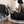 Load image into Gallery viewer, Coussin de sol Arico de couleur noir avec femme lisant dans un salon.
