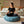 Load image into Gallery viewer, Coussin de sol Arico de couleur récif avec femme en position méditation. 
